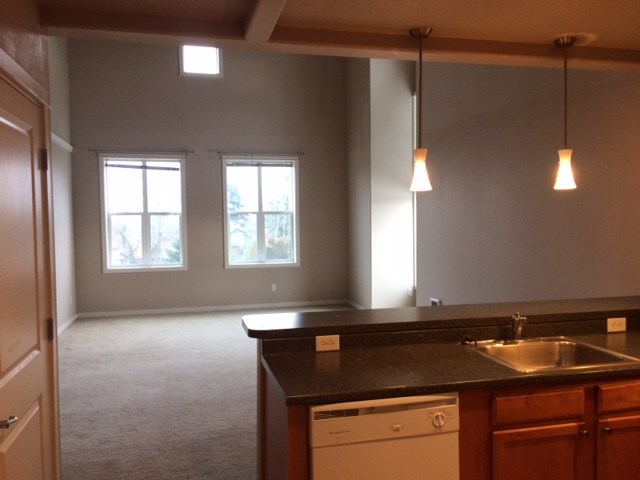 an empty kitchen and living room in a house