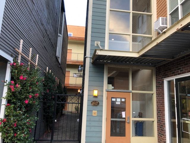 a blue house with a orange door and a window