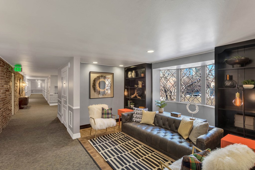 a living room with a leather couch and a rug