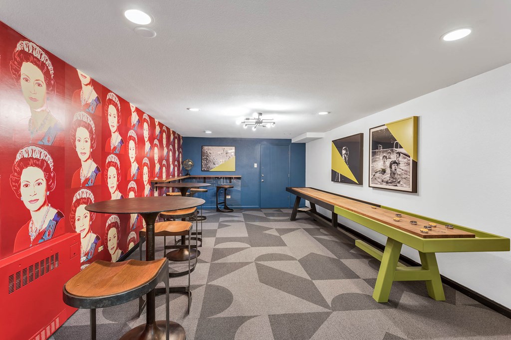 a game room with tables and chairs and a wall mural