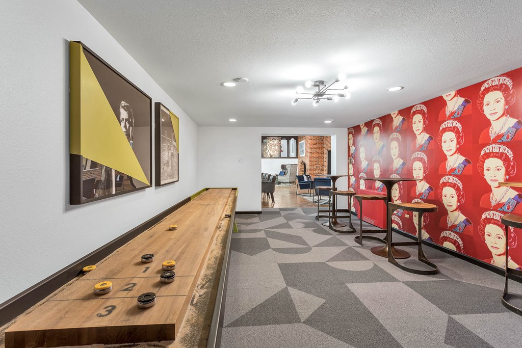 a game room with a long wooden table and chairs and a wall mural of children