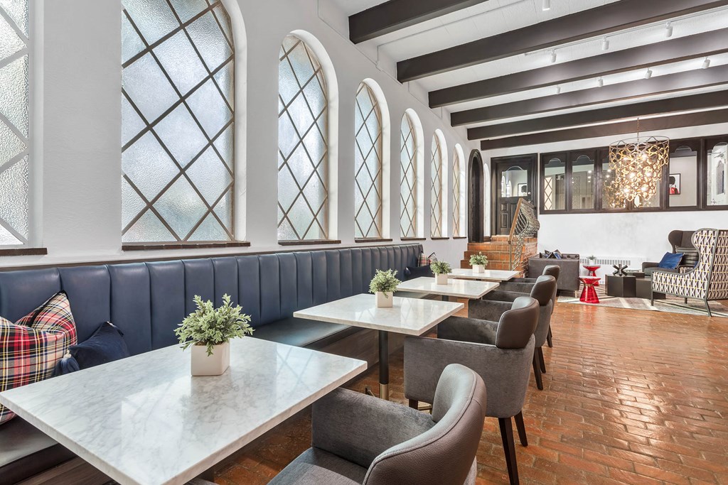 a restaurant with large windows and tables and chairs