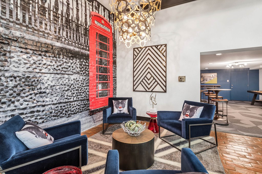 a living room with blue chairs and a red door