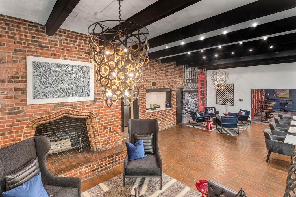 a living room with a brick wall and a fireplace