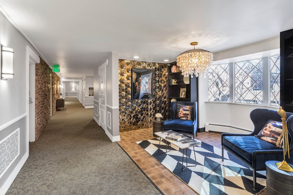 a living room with blue furniture and a checkered rug