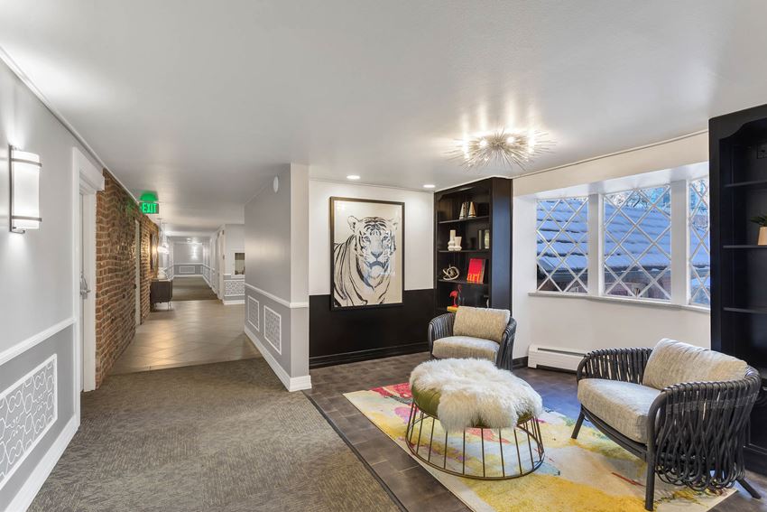 a living room with a couch and chairs and a rug