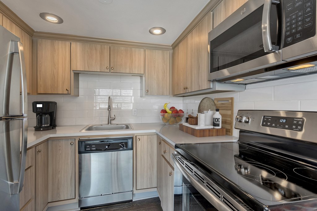 a kitchen with stainless steel appliances and wooden cabinets