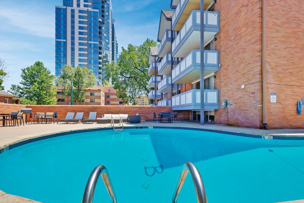 View of a swimming pool with the Brit apartments in the background