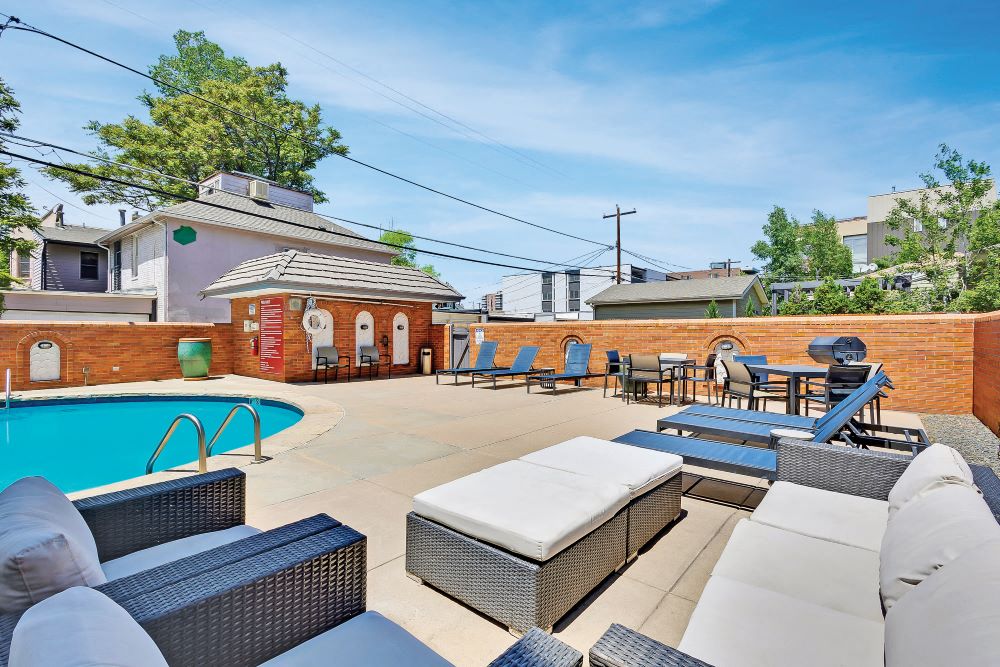 Patio furniture and view of the pool at the Brit apartments