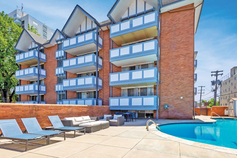 View of a swimming pool with the Brit apartments in the background
