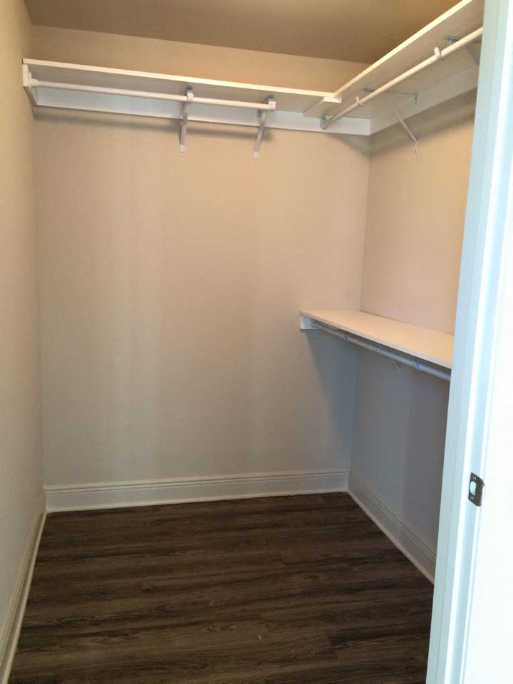 a room with a desk and a shelf in it