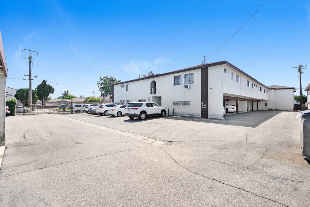 a large white building with cars parked in front of it