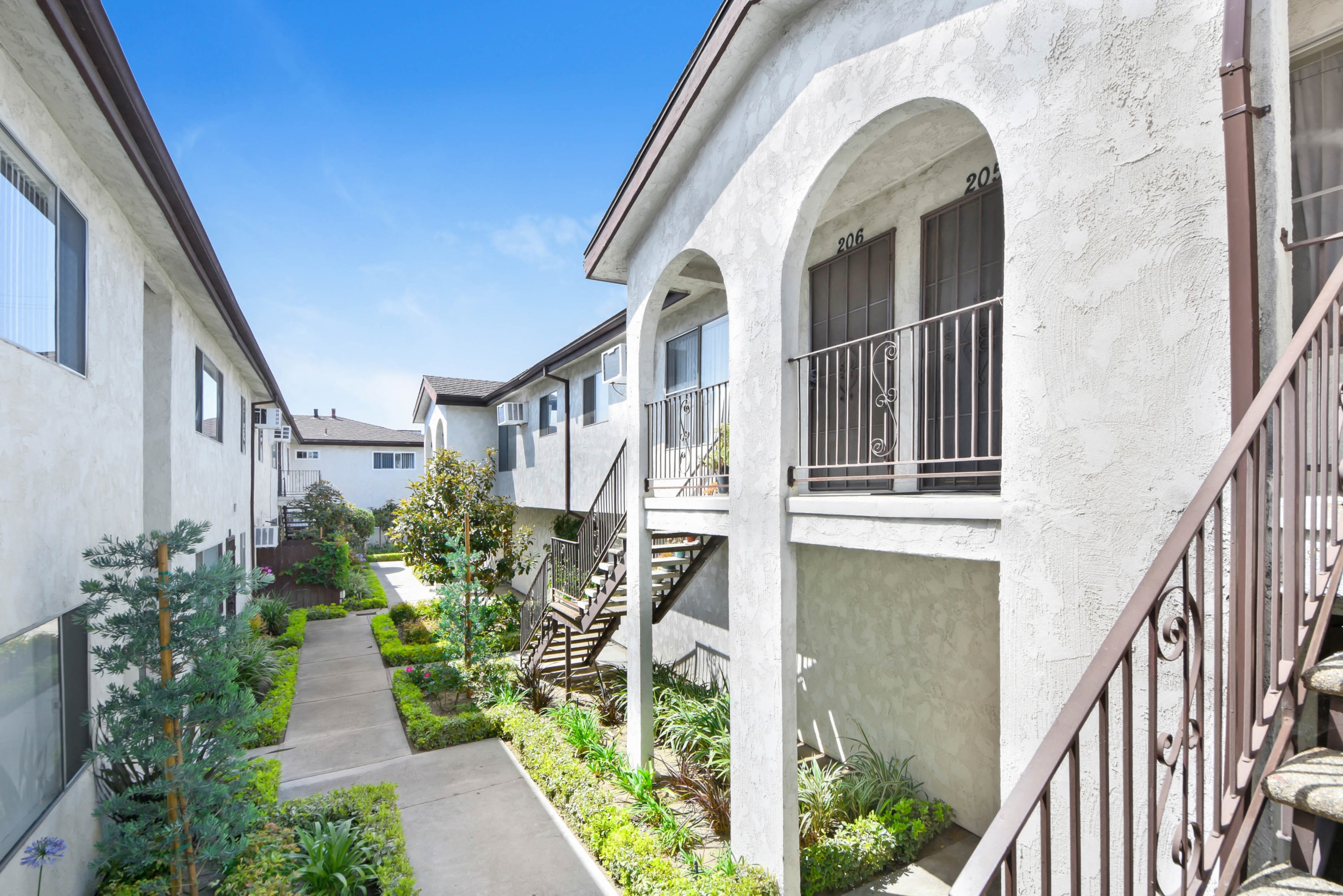a row of apartments with stairs and balconies