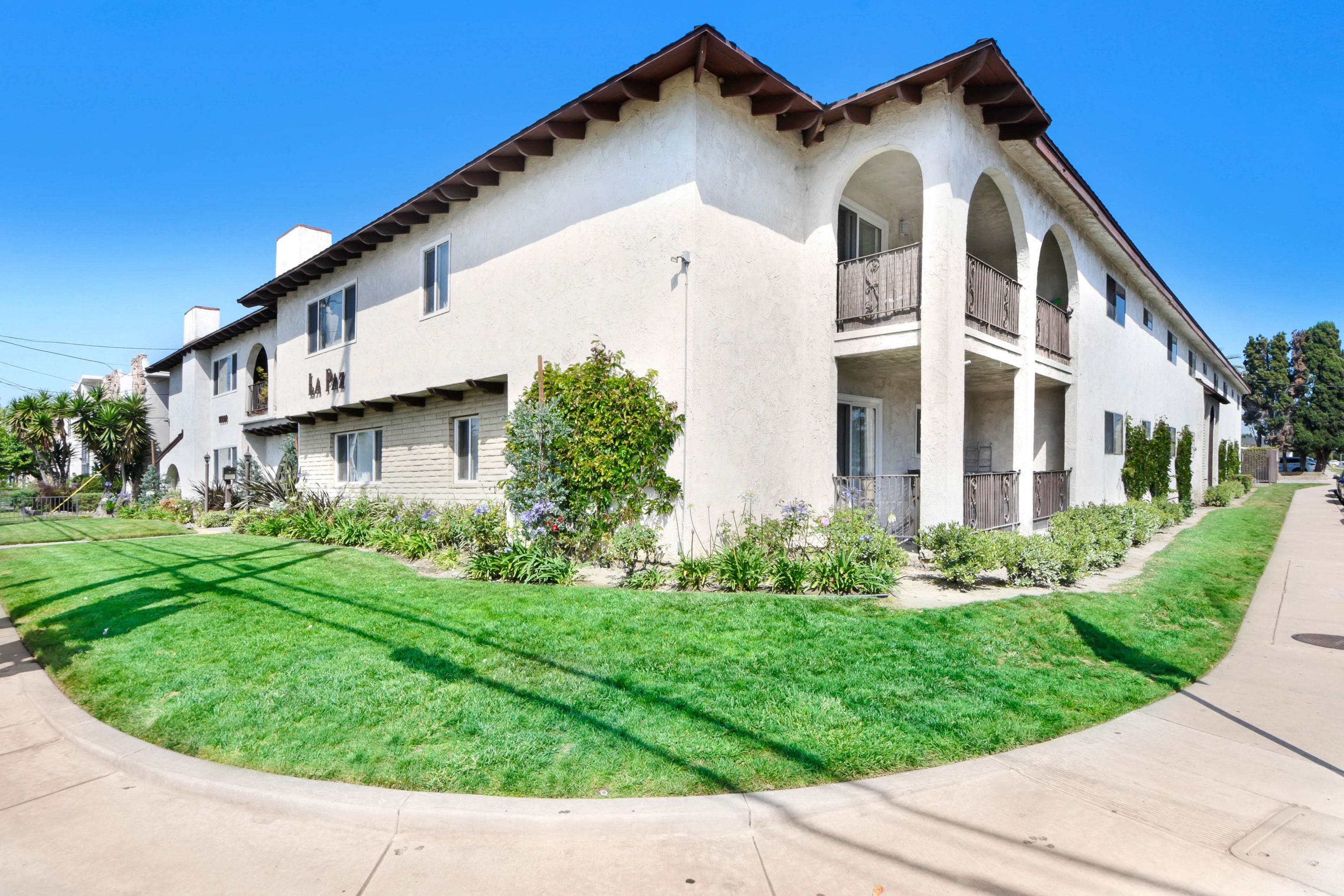 a white house with a yard in front of it