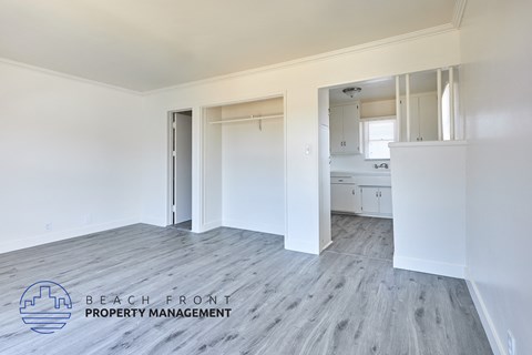A room with a logo of Beach Front Property Management on the floor.