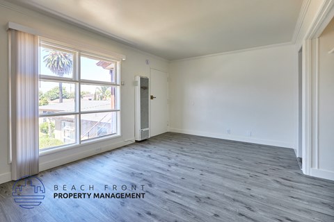 A spacious room with a view of the beach through the windows.