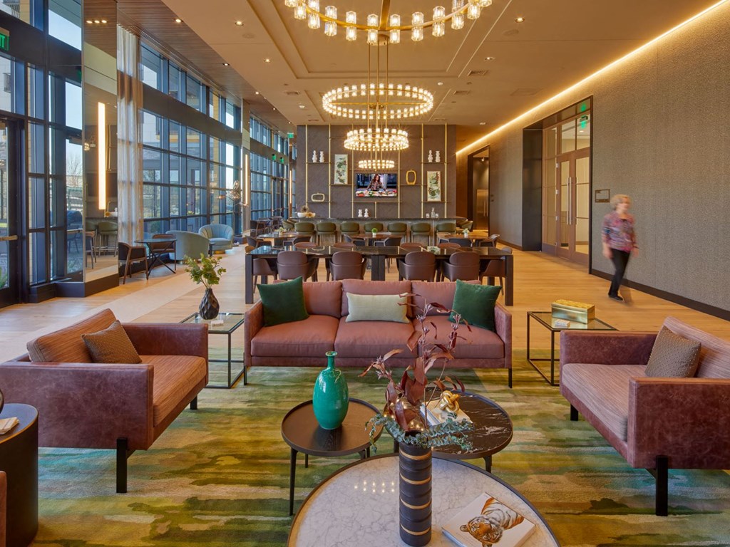 a large lobby with couches and tables and chairs