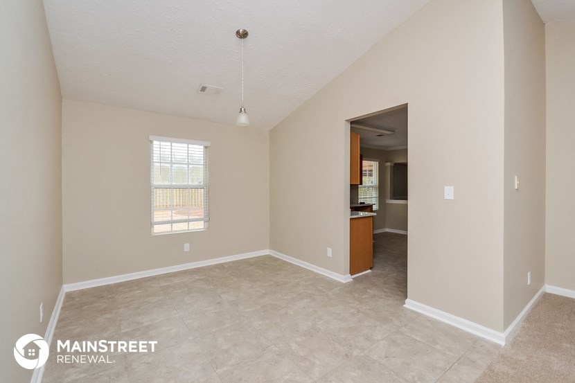 the living room and kitchen of this manufactured home are spacious and clean