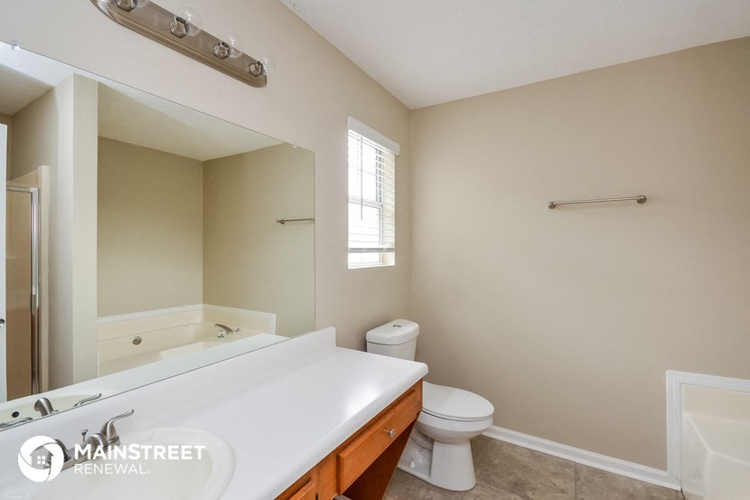 a bathroom with a sink and a toilet and a mirror