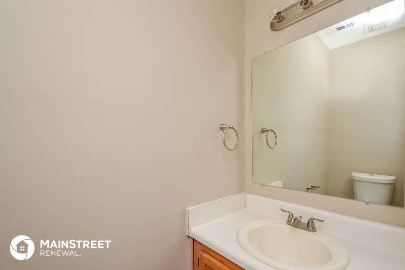 a bathroom with a sink and a mirror and a toilet