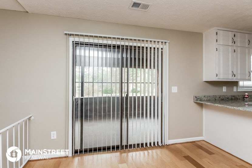 the living room with sliding glass doors to the patio