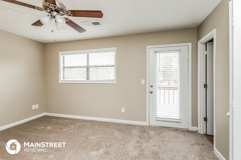 the master bedroom is spacious and has a ceiling fan