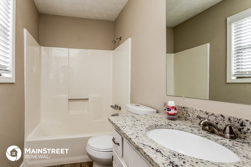 a bathroom with a sink and a toilet and a shower