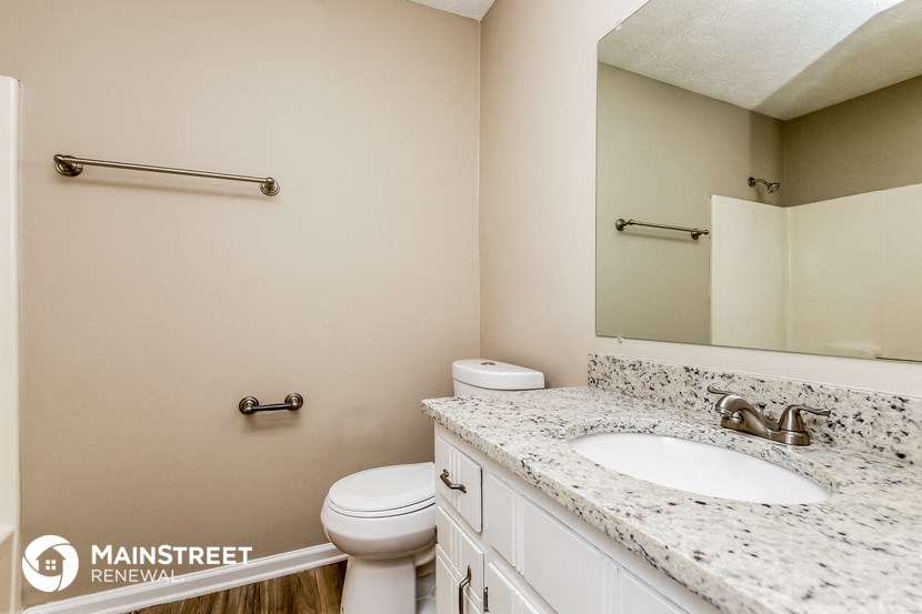 a bathroom with a sink and a toilet and a mirror