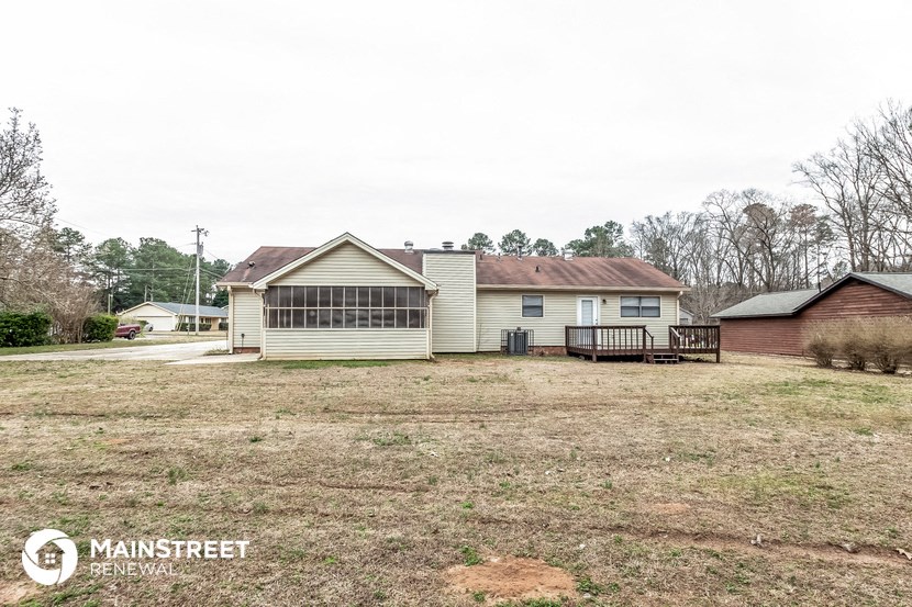 a small white house with a yard in front of it