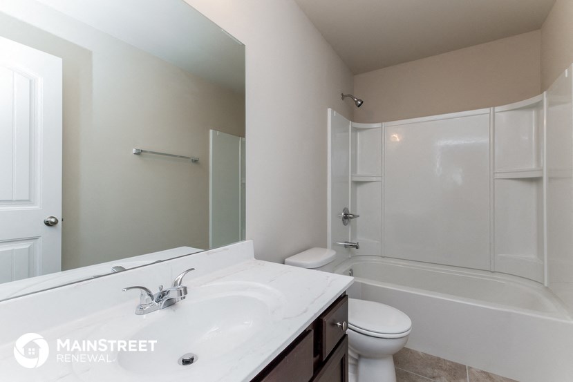 a bathroom with a sink and a toilet and a shower