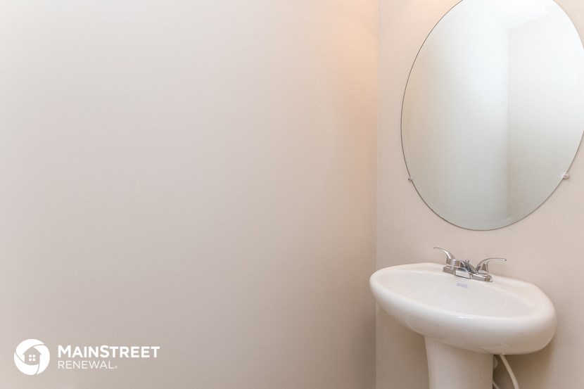 a white bathroom with a sink and a mirror