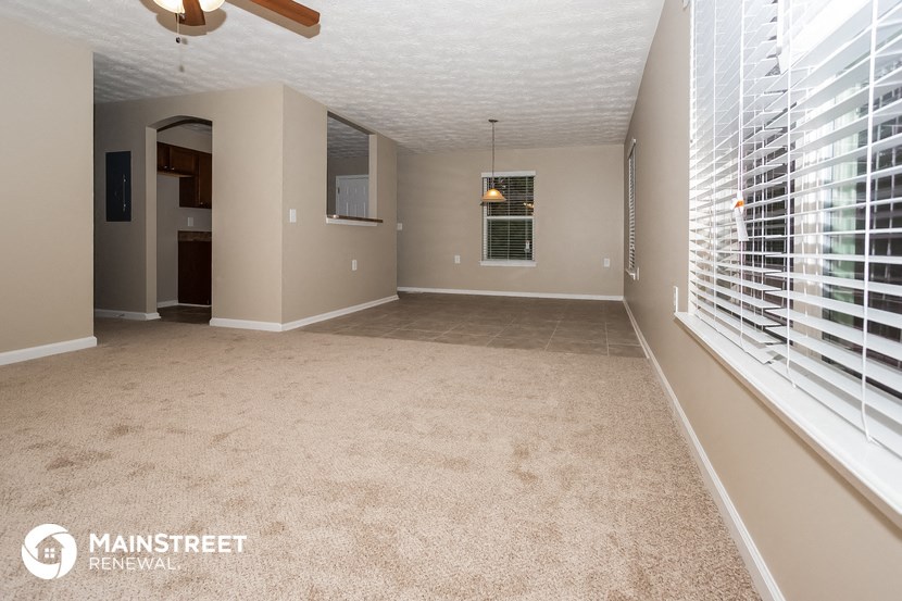 an empty living room with a large window