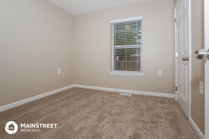 a empty room with a window and a door