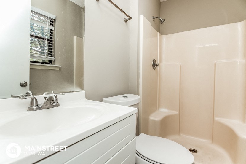 a bathroom with a sink and a toilet and a shower