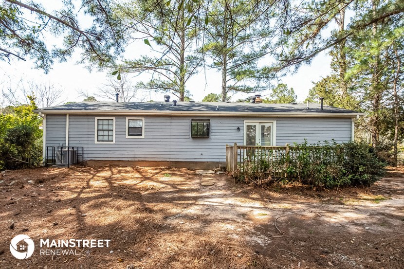a blue house with a yard and trees