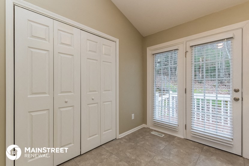 the master bedroom has two closets and a large window