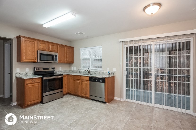 a kitchen with wooden cabinets and stainless steel appliances