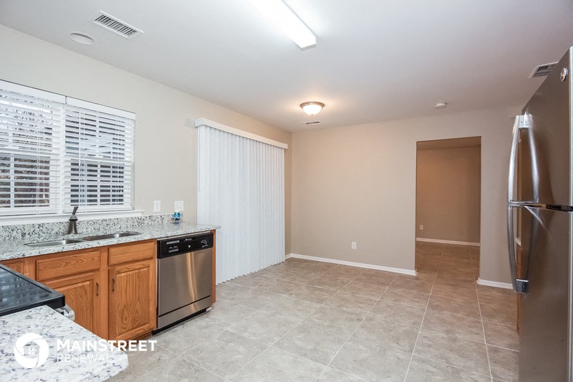 a kitchen with stainless steel appliances and a large window