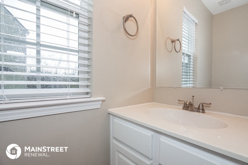 a small bathroom with a sink and a window
