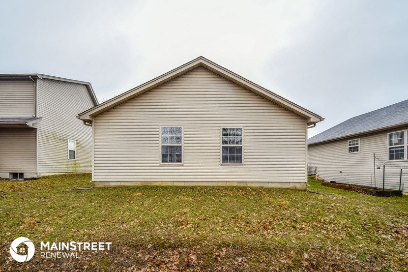 side view of a house with a yard in front of it