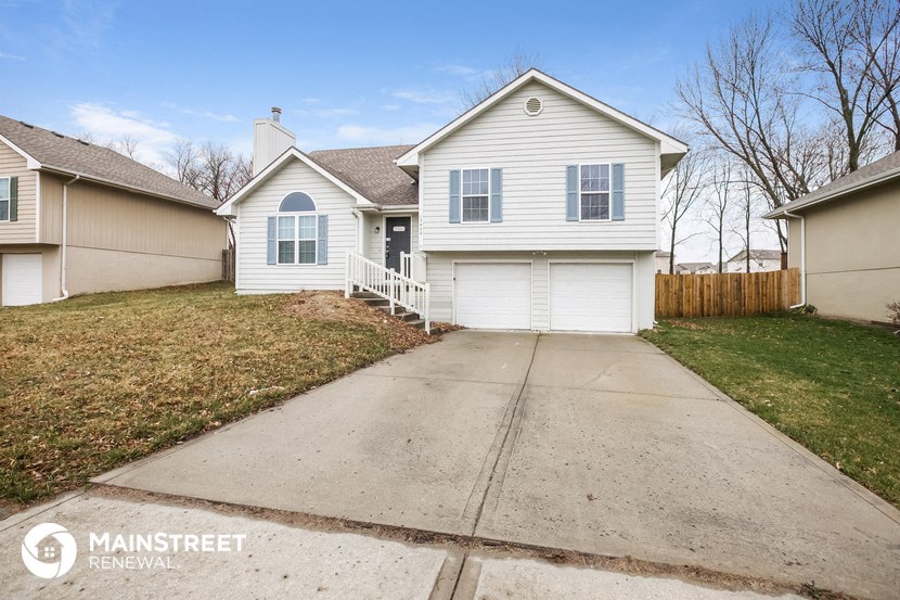 a white house with a sidewalk in front of it