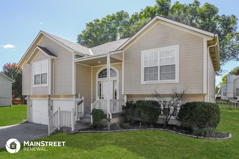 the exterior of a home with a front porch and a lawn