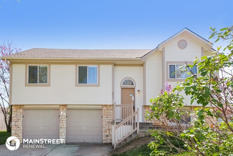 a white house with a front porch and a driveway