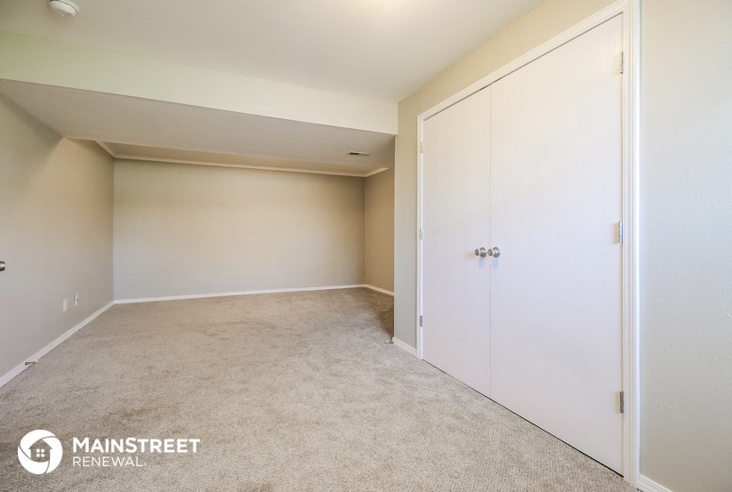 a bedroom with a closet and a white door