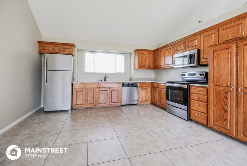 a kitchen with wooden cabinets and stainless steel appliances
