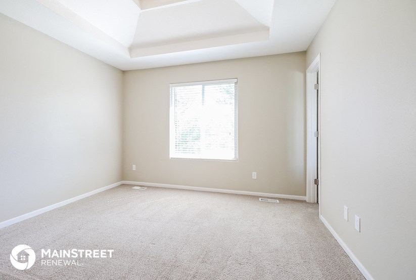 an empty room with a window and a door