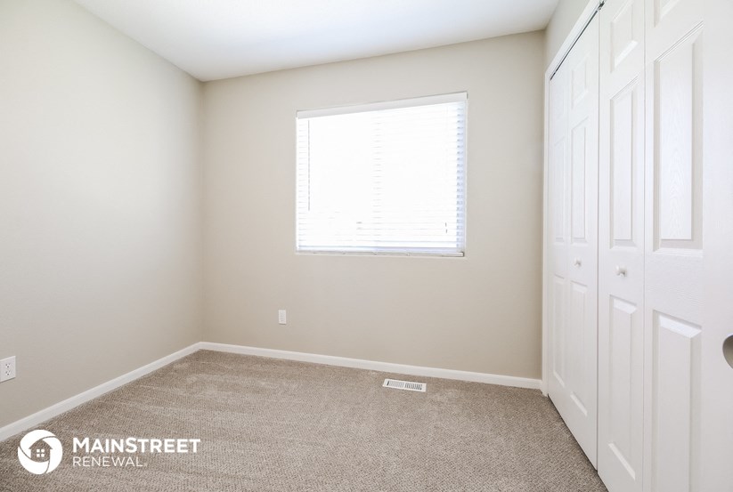 a bedroom with two closets and a window