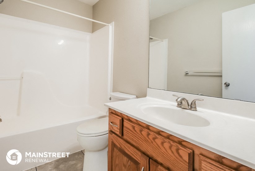 a bathroom with a sink and a toilet and a mirror