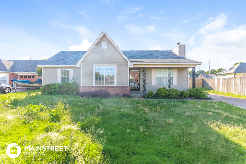 a small white house with a lawn in front of it