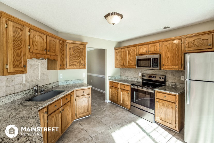a kitchen with wooden cabinets and stainless steel appliances